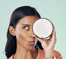 Image showing Beauty, face or wellness woman with coconut for natural skincare glow, organic cosmetics or eco friendly makeup. Pucker, fruit nutrition benefits or person with clean healthy food on green background