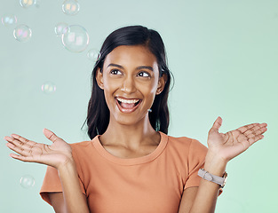 Image showing Happy, bubbles and wow with woman in studio for creative, magic and rainbow. Playful, funny and laughing with female and excited and isolated on background for bright, happiness and freedom