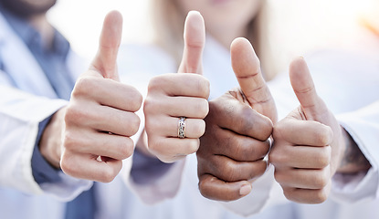 Image showing Hands, doctors and thumbs up together in closeup for motivation, agreement and team building in hospital. People, teamwork and hand gesture for diversity, support and trust for healthcare in clinic