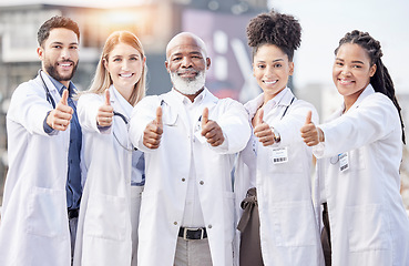 Image showing Portrait, collaboration and thumbs up with a team of doctors standing outside of a hospital together. Teamwork, thank you or motivation with a team of professional healthcare workers feeling positive