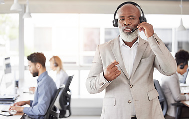 Image showing Black man, call center and consulting manager on headphones for customer service or agent support at office. African American, senior or businessman consultant talking on headset for online advice