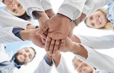 Image showing Hand stack, doctors and below group with smile for motivation, success and team building in hospital. People, teamwork and hands together for solidarity, support and goals for healthcare in clinic