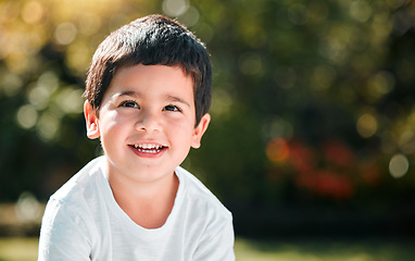 Image showing Children, thinking and mockup with a boy in a park or garden, alone outdoor during a summer day. Kids, idea and smile with a happy male child outside in nature for freedom on a blurred background