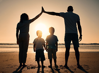 Image showing Family, sunset and outdoor silhouette at beach with children and parents together at sea for security. Man, woman and kids from back on holiday or vacation at ocean with love, care and support