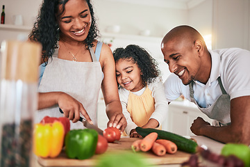 Image showing Family, cut and cooking vegetables together or learning chef skill with parents and child in kitchen. Nutrition, healthy food and organic with people teaching and learn to cook at home with bonding