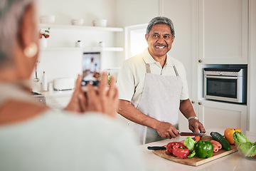 Image showing Kitchen cooking, senior couple and phone picture of old man, husband or nutritionist person with memory photo. Vegan, vegetables or people recording web video, smile or cutting lunch food ingredients