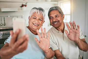 Image showing Video call, waving and elderly couple on phone, happy and smile in their home kitchen. Smartphone, love and old people greeting, excited and cheerful for online conversation and enjoying retirement