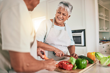 Image showing Cooking vegetables, kitchen and senior couple cutting ingredients, prepare food and smile on romantic home date. Health nutritionist, culinary and hungry man, woman or people bonding over lunch meal