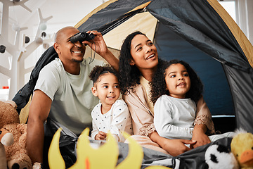 Image showing Family, living room and tent with kids, games and toys for bonding, love and playing together. Parents, girl children and looking with mom, dad or camping game in home with happiness on lounge floor