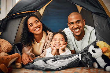 Image showing Parents, girl and portrait in tent at house with toys, games and smile with bonding, love and playing together. Mother, father and kid with camping game in family home with happiness on lounge floor