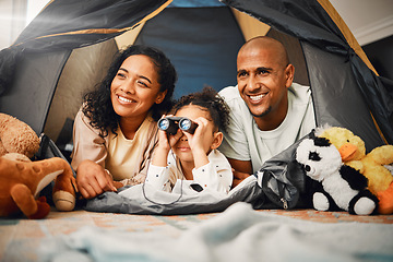 Image showing Parents, girl and binoculars in tent, home and smile for games, toys or bonding with love for playing together. Mom, kid and dad with camping game, looking or search in house with happiness on floor