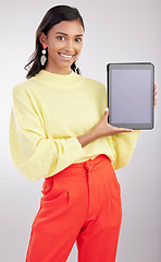 Image showing Tablet, mockup and portrait of woman isolated on a white background for fashion e commerce, sale or promotion space. Happy indian person or model with gen z clothes on digital tech mock up in studio