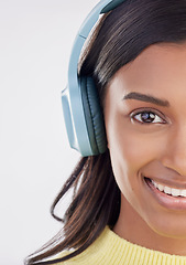 Image showing Portrait, headphones and half with a woman in studio on a gray background listening to music. Face, happy and smile with an attractive young female streaming audio using a subscription service