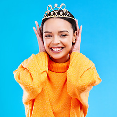 Image showing Excited, crown and portrait of woman in studio for celebration, princess and party. Smile, beauty and fashion with female and tiara on blue background for achievement, winner and prom event