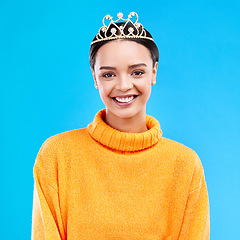 Image showing Winner, crown and portrait of woman in studio for celebration, princess and party. Smile, beauty and fashion with female and tiara on blue background excited for achievement, winner and prom event