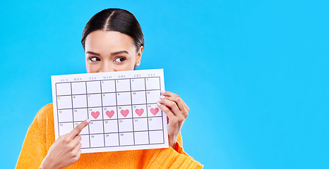 Image showing Calendar, period and woman on blue background with heart for schedule, planning and menstruation in studio. Reminder mockup, monthly and eyes of girl with poster for date, weekly planner and cycle