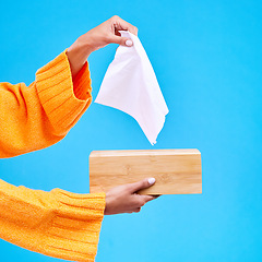 Image showing Tissue, box and hands of woman on blue background for sinus, sickness and flu on blue background. Healthcare mockup, paper and girl with wipe, napkin and handkerchief for hygiene, allergy and sneeze