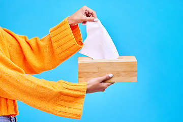 Image showing Box, blue background and hands of woman with tissues for flu, sickness and sinus mockup in studio. Healthcare, toiletries and girl with handkerchief, napkin and paper for cleaning, allergy and sneeze