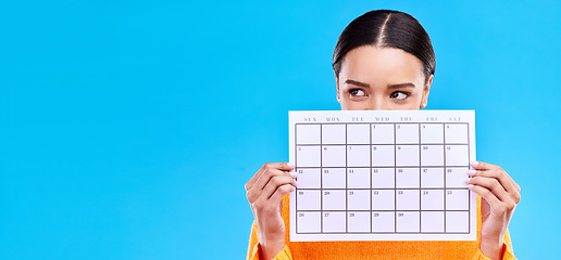 Image showing Calendar, thinking and woman on blue background with poster for schedule, planning and agenda in studio. Time management, strategy and girl with month template for date, weekly planner and event