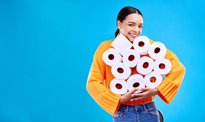 Image showing Toilet paper, happiness and woman portrait with mockup and home inventory stock. Isolated, blue background and studio with a young female holding tissue rolls with a happy smile and joy with mock up