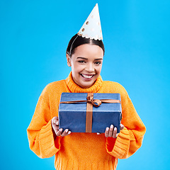 Image showing Woman, portrait smile and gift in studio for birthday present, event or celebration against a blue background. Happy female smiling and holding gifts or box for party, surprise or giving on mockup