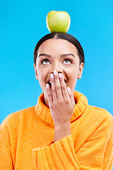 Image showing Apple head balance, woman face and surprised with fruit product for weight loss benefits, healthy lifestyle or body detox. Organic food diet, nutritionist studio and shocked person on blue background