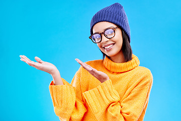 Image showing Woman palm, happiness and girl happy in a studio with promotion and announcement. Model, isolated and blue background with mockup of a gen z and cool young female hands show marketing with smile