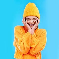 Image showing Happiness, excited and woman with youth in studio ready for cold weather with winter hat. Isolated, blue background and smiling with a happy young and gen z person with a smile, beanie and joy