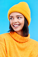 Image showing Happiness, excited and woman with youth cap in studio ready for cold weather with winter hat. Isolated, blue background and smiling with a happy young and gen z person with a smile, beanie and joy