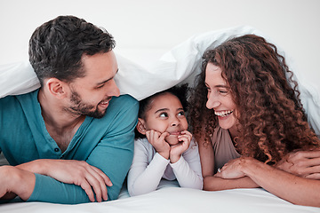 Image showing Family, parents are happy with child in bed and relax under blanket in bedroom with smile, love and care. Spending time together, bonding and happiness, man and woman with young girl at home