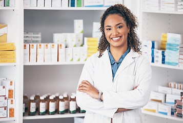 Image showing Pharmacy, pharmacist or portrait of woman with arms crossed or smile in customer services or clinic. Healthcare help desk, wellness or happy doctor smiling by medication on shelf in drugstore