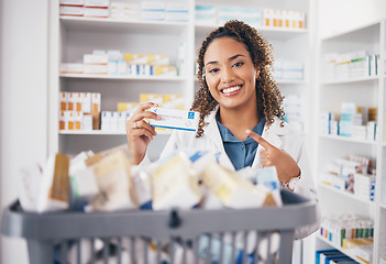 Image showing Pointing, pharmacy or portrait of happy woman with medicine in healthcare retail or wellness clinic. Smile, help desk or pharmacist doctor smiling to promote medication products or pills in drugstore