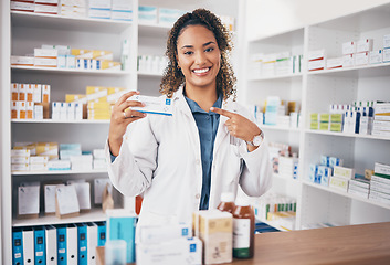 Image showing Pointing, pharmacist or portrait of happy woman with medicine in customer services or wellness clinic. Healthcare help desk, pharmacy or doctor smiling to promote medication or pills on drugstore