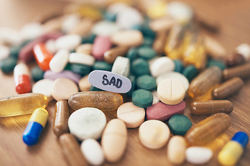 Image showing Healthcare, depression or table with medicine pills or supplements products at drugstore clinic. Pharmaceuticals background, blur or medical vitamins, stress anxiety tablets or sad medication closeup