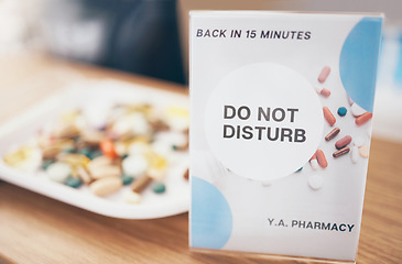 Image showing Sign, healthcare and medication in an empty pharmacy for the treatment or cure of disease and insurance. Do not disturb, medical and medicine box, package or container in a pharmaceuticals clinic