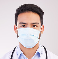 Image showing Covid, doctor and portrait of man in studio with protection, safety or corona compliance on white background. Face, mask and male healthcare worker at hospital for treatment and disease prevention