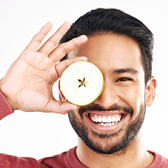 Image showing Apple, fruit and portrait of man with smile on white background for diet, nutrition and detox. Healthy body, food and isolated face of happy male with slice for breakfast, snack and lunch in studio