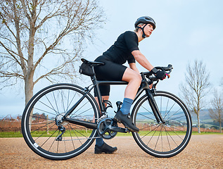 Image showing Ready, cycling and fitness with woman in nature for training, workout and sports cardio. Health, relax and thinking with female cyclist riding on bike in outdoor for exercise, endurance and challenge
