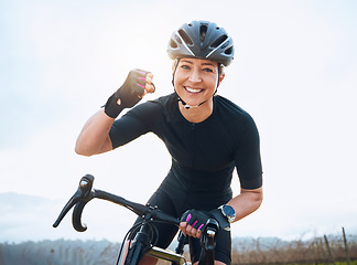 Image showing Fitness, celebration and portrait of woman cycling with power fist, success or victory in the countryside. Happy, sports and face of lady cyclist celebrating workout achievement, milestone or winning