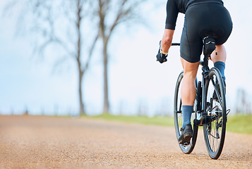 Image showing Bicycle, outdoor and person on a bike ride with mockup for sports race on a gravel road. Fitness, exercise and fast athlete doing sport training in nature on a park trail for cardio and workout