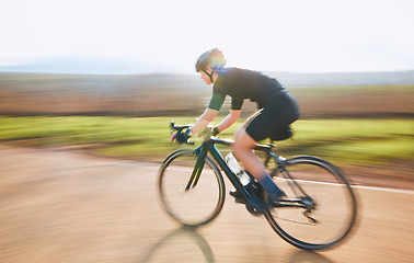 Image showing Bicycle, ride outdoor and person on a bike with speed for sports race on a gravel road. Fitness, exercise and fast athlete doing sport training in nature in a park for cardio and healthy workout