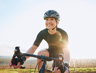 Image showing Cycling, fitness and happy with woman in park for training, workout and cardio health. Exercise, travel and freedom with female cyclist riding on bike in nature for adventure, journey and transport