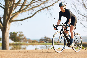 Image showing Fitness, bicycle and woman cycling in a forest for sports, exercise and morning cardio in nature. Training, bike and female enjoying workout in a park, freedom and energy, performance and endurance