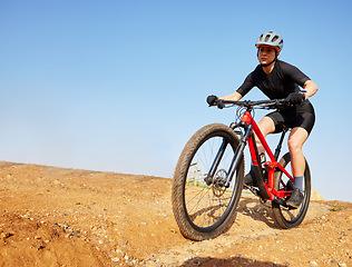 Image showing Bicycle, ride outdoor and woman on a bike with cycling for sports race on a gravel road. Fitness, exercise and athlete doing sport training in nature on trail for cardio and workout with mockup