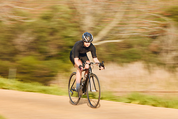 Image showing Bicycle, sports and woman cycling in a forest for fitness, exercise and morning cardio in nature. Training, bike and female workout in a park, freedom and energy, performance and intense endurance