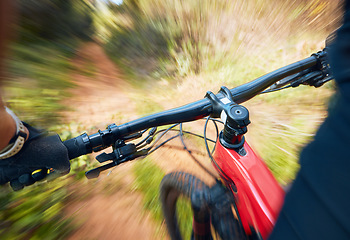 Image showing Bike, cycling and motion blur with a sports person holding handle bars while riding outdoor closeup pov. Bicycle, fitness and speed with a cyclist or athlete mountain biking in nature during summer