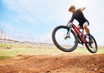 Image showing Bicycle, countryside and woman on a bike with speed for sports race on a dirt road. Fitness, exercise and athlete doing sport training in nature on a park trail for mockup cardio and cycling workout