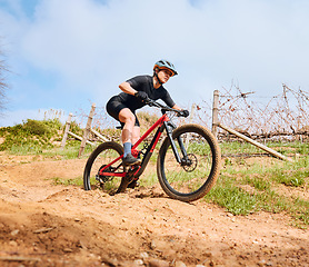 Image showing Bicycle fitness, countryside road and woman on a bike with speed for sports race on cycling path. Adventure, biker exercise and fast athlete doing training in nature on a trail for cardio and workout