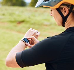 Image showing Smartwatch, heart rate and woman cyclist outdoor checking pulse for bike and cycling fitness. Exercise, wellness app and female athlete doing a time check for bicycle race in nature by grass