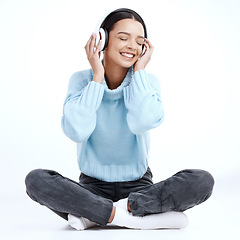 Image showing Music headphones, woman and smile in white background, isolated studio and floor. Happy female model listening to sound, streaming album and audio connection of song, podcast subscription and radio